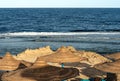 Red Sea beach with straw umbrellas - Marsa Alam Egypt Africa Royalty Free Stock Photo