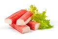 Red sea crab stick with green lettuce, close-up, isolated on white background Royalty Free Stock Photo