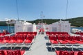 Red seats on the deck of a ferry