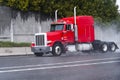 Red semi truck rig with long cab on raining highway Royalty Free Stock Photo