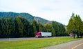 Red semi truck trailer nice rig cargo on green natural road Royalty Free Stock Photo