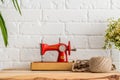 Red sewing machine on a wooden table. Sewing industry. Diy Royalty Free Stock Photo