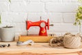 Red sewing machine on a wooden table. Sewing industry. Diy Royalty Free Stock Photo