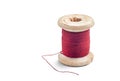 Red sewing thread on an old bobbin