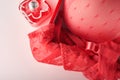 Red sexy bra and panties in box on pink background. Women sexy underwear set with roses and perfume. Gift Idea for Womens Day or V