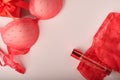 Red sexy bra and panties on pink background. Women sexy underwear set with roses and perfume. Gift Idea for Womens Day or Valentin