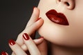 Red lips and nails closeup. Open mouth. Manicure and makeup