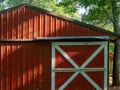 Red shed on farm with sliding door with white trim Royalty Free Stock Photo