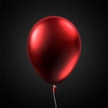 Red shiny balloon isolated on grey background.