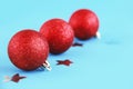 Red shiny christmas toys balls on the christmas tree for new year holiday Royalty Free Stock Photo