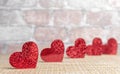 Red shiny hearts on a brick wall background. Valentine`s day concept Royalty Free Stock Photo