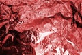 Red shiny metallic foil crumpled texture effect, maroon soft wrinkled background, festive fashion pink glossy backdrop