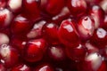 Red shiny pomegranate seeds on white background tasty and organic fruit peeled