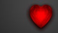 Red shiny reflective glass heart on grey background