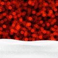 Red shiny winter background with snow and lights.