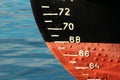 Red ship hull with waterline and draft scale measure Royalty Free Stock Photo