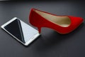 Red shoes and broken phone on grey background Royalty Free Stock Photo