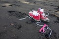 Red shoes and girls sunglasses on Waipio Valley black sand beach, Hawaii