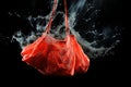 Red shopper bag with water splash on black background. Buying power