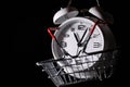 Red shopping basket with white retro alarm clock in it. Lose time. Buy time. Break. Motivation. Business solutions. Success. Royalty Free Stock Photo