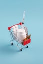 Red shopping cart with medicinal pills and tablets closeup