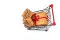 Red shopping cart with three presents boxes from above and beside