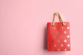 Red Shopping Paper Bag With Star Pattern On Background, Space For Text