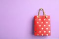 Red shopping paper bag with star pattern on background, space for text Royalty Free Stock Photo