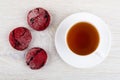 Red cookies, cup of tea on saucer on table. Top view Royalty Free Stock Photo