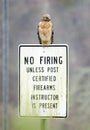 Red-shouldered Hawk perched on firing range sign, Georgia, USA Royalty Free Stock Photo