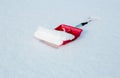 Red shovel for snow removal lying in the snow Royalty Free Stock Photo
