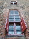 Red shutters on old castle window Royalty Free Stock Photo