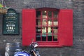 Red shutters and a pub window decorated before Christmas Royalty Free Stock Photo