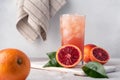 Red Sicilian orange juice in a glass and fresh oranges