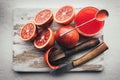 Red sicilian orange pieces on wooden board closeup