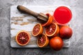 Red sicilian orange pieces on wooden board closeup