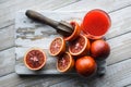 Red sicilian orange pieces on wooden board closeup