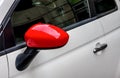 Red side mirror on white car. Royalty Free Stock Photo