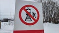 A red sign with a black silhouette of a person stepping on the railway tracks, which prohibits passengers or other Royalty Free Stock Photo