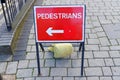 Red sign directing pedestrians