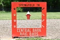 Red Sign with a fire hydrant in the background  signifying `Central Bark Dog Days` in Springfield Tennessee Royalty Free Stock Photo