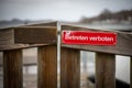 On red sign at a gate is written in german: Betreten verboten