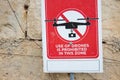 A red sign that reads `Use of drones is prohibited in this zone` Royalty Free Stock Photo