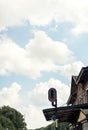 Red signal light at train station with blue cloudy sky. Royalty Free Stock Photo