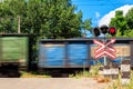 Red signal of semaphore and stop sign in front of railroad crossing with train passing Royalty Free Stock Photo