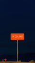 Red signpost with the words Welcome against the night landscape backdrop. Welcome button concept. Generative AI