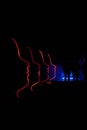 Red silhouttes of 4 faces at a light show