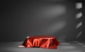 Red silk cover product stage in dark room with shadow overlay. Simple mockup background for advertising. Glossy satin