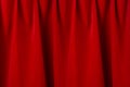 Red silk curtains with smooth waves and dark shadows as rich abstract theatre background. Royalty Free Stock Photo