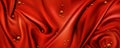 Red silk draped fabric background with gold pearls Royalty Free Stock Photo